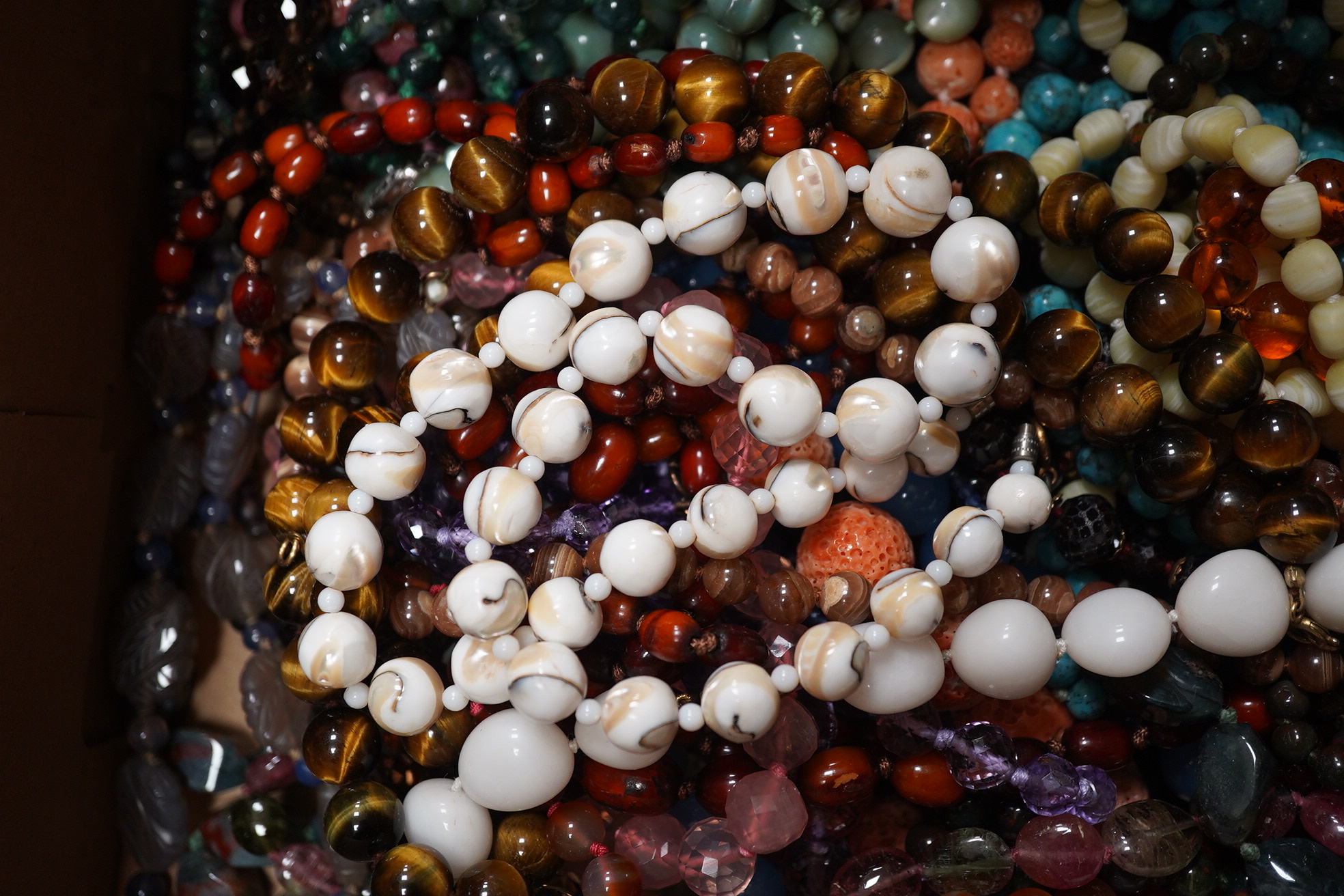 A quantity of assorted bead necklaces including, coral, various agates, turquoise cat's eye quartz, rock crystal, tiger's eye quartz, amethyst, aquamarine etc. Condition - poor to fair to good